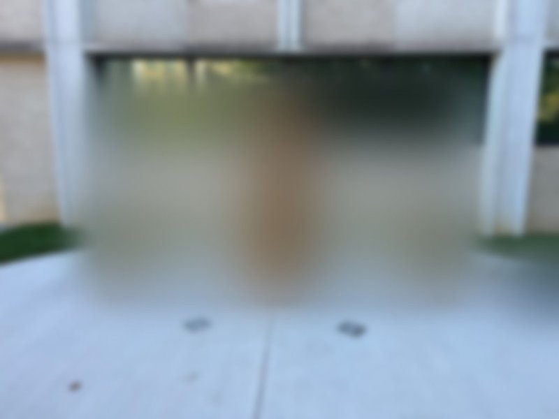 A soft-focus preview of the memorial bench, still under wraps, outside the Charles George VA Medical Center